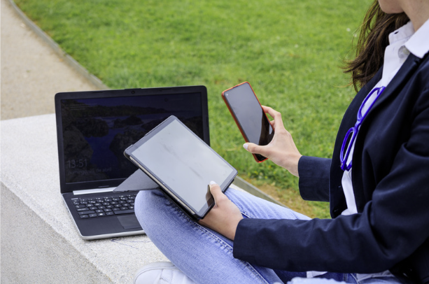 woman with a laptop, tablet and cellphone