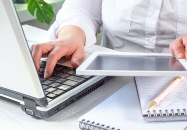 female using a laptop and tablet